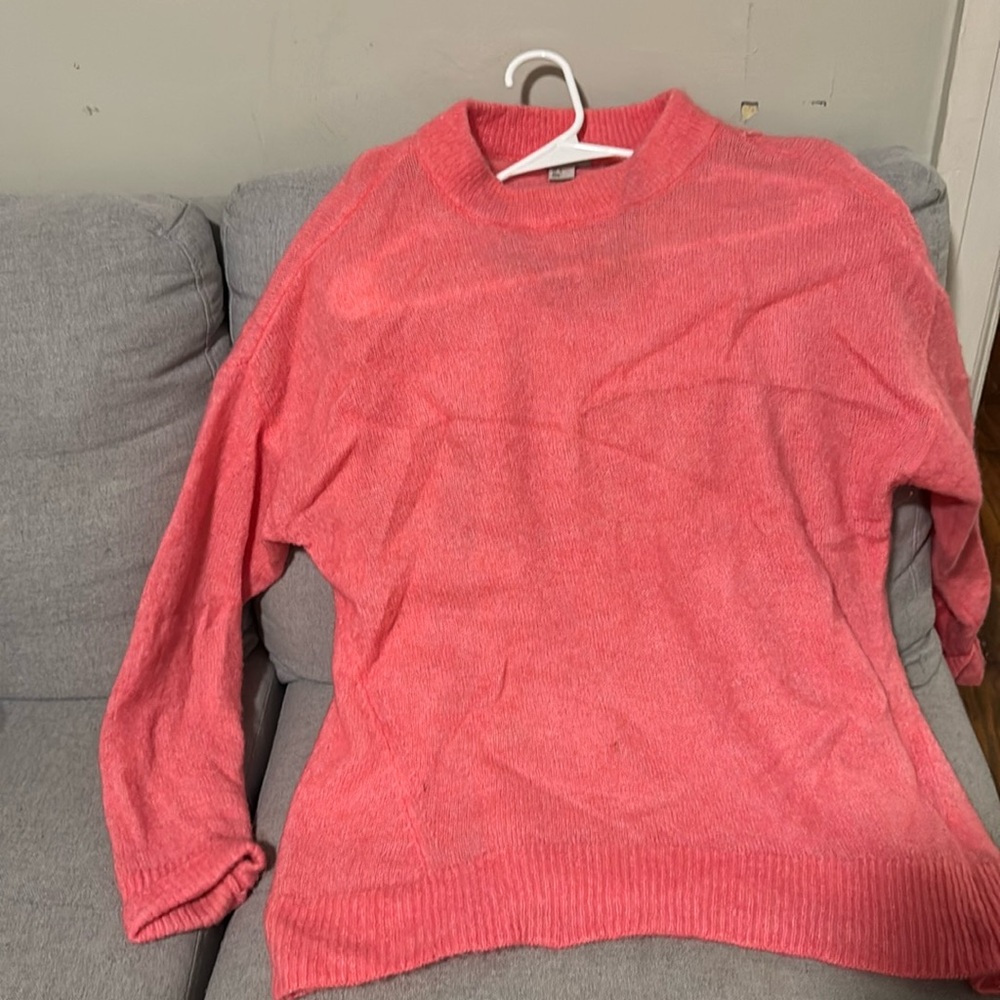 This is a cute pink H&M sweater in a size medium